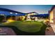 Expansive backyard with putting green, outdoor kitchen, and lounge areas at 20795 W San Juan Ave, Buckeye, AZ 85396