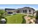 Stunning backyard with putting green, outdoor dining, and cozy lounge area at 20795 W San Juan Ave, Buckeye, AZ 85396