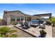 Inviting backyard features a fire pit, comfortable seating, and an outdoor kitchen at 20795 W San Juan Ave, Buckeye, AZ 85396