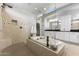 Bright bathroom with a glass shower, large tub, white cabinetry, and tile details at 20795 W San Juan Ave, Buckeye, AZ 85396
