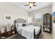 Cozy bedroom with a black iron bed frame, accent rug, and window with stylish shutters at 20795 W San Juan Ave, Buckeye, AZ 85396