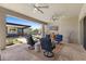 Spacious covered patio features comfortable seating, ceiling fans, and views of the desert landscape at 20795 W San Juan Ave, Buckeye, AZ 85396