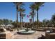 Beautiful fountain and palm trees in the Verrado community with an American flag and building in the background at 20795 W San Juan Ave, Buckeye, AZ 85396