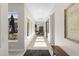 Bright and airy hallway featuring tile flooring, large windows, and elegant decor at 20795 W San Juan Ave, Buckeye, AZ 85396