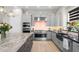 Gourmet kitchen with stainless appliances, gray cabinets, tiled backsplash, and granite countertops, perfect for cooking! at 20795 W San Juan Ave, Buckeye, AZ 85396