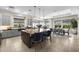 Open-concept kitchen with a large island, pendant lighting, and seamless flow into the dining area at 20795 W San Juan Ave, Buckeye, AZ 85396