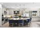 Gourmet kitchen features stainless appliances, large island with seating, and a convenient cooktop at 20795 W San Juan Ave, Buckeye, AZ 85396