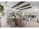 Beautiful living room with tile floors, beamed ceilings, and open to the kitchen area, great for entertaining at 20795 W San Juan Ave, Buckeye, AZ 85396