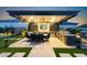 Covered outdoor dining area with kitchen and TV, perfect for entertaining at 20795 W San Juan Ave, Buckeye, AZ 85396