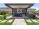 Outdoor kitchen featuring a built-in barbecue, bar seating, a ceiling fan and lush landscaping at 20795 W San Juan Ave, Buckeye, AZ 85396