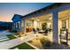 Inviting covered patio with comfortable seating, a TV, and seamless indoor-outdoor living at 20795 W San Juan Ave, Buckeye, AZ 85396