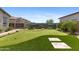 Beautiful backyard features a putting green, desert landscaping, and mountain views at 20795 W San Juan Ave, Buckeye, AZ 85396