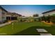 Backyard putting green offers a fun recreational space with desert landscape backdrop at 20795 W San Juan Ave, Buckeye, AZ 85396