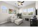 Bright sitting room featuring neutral tones, large windows, comfortable seating, and a ceiling fan at 20795 W San Juan Ave, Buckeye, AZ 85396