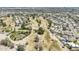Aerial view of the golf course, pond, trees, and nearby houses at 2178 E Golf Ave, Tempe, AZ 85282