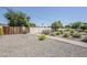 Beautiful backyard with a gravel landscape, lush plants, and a charming brick-paved pathway at 2178 E Golf Ave, Tempe, AZ 85282