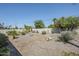 Well-maintained backyard featuring xeriscape landscaping with gravel, various plants, and a white trellis at 2178 E Golf Ave, Tempe, AZ 85282