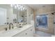 Bathroom with double sink vanity, walk-in shower, and stylish fixtures at 2178 E Golf Ave, Tempe, AZ 85282