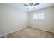 Bedroom features neutral carpeting, a ceiling fan, and shuttered window at 2178 E Golf Ave, Tempe, AZ 85282