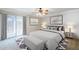 Main bedroom with neutral decor, bench, and sliding glass door to outdoor area at 2178 E Golf Ave, Tempe, AZ 85282