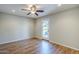 Bedroom featuring laminate flooring, ceiling fan, recessed lighting, and a glass panel door to the backyard at 2178 E Golf Ave, Tempe, AZ 85282