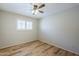 Bedroom featuring laminate flooring, a ceiling fan, and a window with light-filtering shades at 2178 E Golf Ave, Tempe, AZ 85282