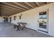 Inviting covered patio with wooden table and chairs, perfect for outdoor dining and relaxation at 2178 E Golf Ave, Tempe, AZ 85282