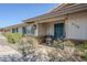 Inviting covered front porch featuring a teal door, exterior lights, and a comfortable chair at 2178 E Golf Ave, Tempe, AZ 85282