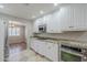 Bright kitchen featuring white cabinets, granite countertops, stainless steel appliances, and tile flooring at 2178 E Golf Ave, Tempe, AZ 85282