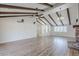 Bright living room featuring wood floors, a brick fireplace, a ceiling fan, and vaulted, beamed ceilings at 2178 E Golf Ave, Tempe, AZ 85282