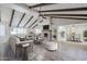 Bright living room boasts wood beam ceiling, brick fireplace, and open layout to dining area and kitchen at 2178 E Golf Ave, Tempe, AZ 85282