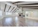 Spacious living room with vaulted ceilings, exposed beams, a brick fireplace, and wood flooring at 2178 E Golf Ave, Tempe, AZ 85282