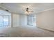 Open living room with sliding glass doors, neutral carpet, and a ceiling fan at 2178 E Golf Ave, Tempe, AZ 85282