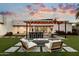 Inviting backyard featuring a fire pit, comfortable seating, and a modern outdoor kitchen at 2225 N 38Th Way, Phoenix, AZ 85008