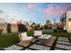 Cozy backyard patio area with comfortable seating around a modern fire pit at 2225 N 38Th Way, Phoenix, AZ 85008