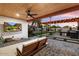 Backyard area with wood ceiling, string lights, TV, BBQ, and patio at 2225 N 38Th Way, Phoenix, AZ 85008
