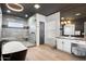 Stylish bathroom featuring a freestanding tub, glass-enclosed shower, and modern vanity with elegant lighting at 2225 N 38Th Way, Phoenix, AZ 85008