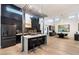 Modern kitchen with black cabinetry, an island with seating, and stainless steel appliances at 2225 N 38Th Way, Phoenix, AZ 85008