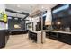 Open kitchen design featuring a central island, black cabinetry, and a seamless flow to the living area at 2225 N 38Th Way, Phoenix, AZ 85008