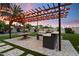 Outdoor kitchen with pergola, built-in grill, and concrete counters, perfect for entertaining at 2225 N 38Th Way, Phoenix, AZ 85008