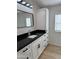 Stylish bathroom with black countertop, modern vanity, and ample storage at 2233 E Behrend Dr # 29, Phoenix, AZ 85024