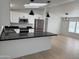 Bright open kitchen with black countertops, white cabinets, and stainless steel appliances at 2233 E Behrend Dr # 29, Phoenix, AZ 85024