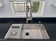 Stainless steel kitchen sink with chrome faucet and window with blinds at 2233 E Behrend Dr # 29, Phoenix, AZ 85024