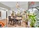 Bright dining room features stylish lighting, hardwood floors, and view of open kitchen at 2302 N Central Ave # 311, Phoenix, AZ 85004