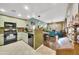 Open concept kitchen featuring modern appliances and a breakfast bar overlooking the living area at 2302 N Central Ave # 311, Phoenix, AZ 85004