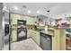 Well-lit kitchen featuring granite counters, stainless steel appliances and light green cabinetry at 2302 N Central Ave # 311, Phoenix, AZ 85004