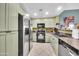 Well-equipped kitchen with stainless steel appliances, granite countertops, and light green cabinetry at 2302 N Central Ave # 311, Phoenix, AZ 85004