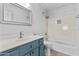 Bathroom featuring a vanity with blue cabinets and a shower/tub combo at 2313 N 87Th Way, Scottsdale, AZ 85257