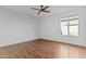Bedroom with ceiling fan, hardwood floors and a bright window at 2313 N 87Th Way, Scottsdale, AZ 85257