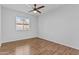 Cozy bedroom with hardwood floors, neutral walls, and a bright window at 2313 N 87Th Way, Scottsdale, AZ 85257